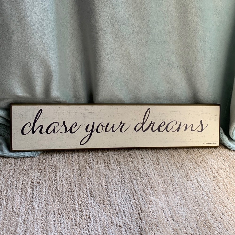 Rustic chase your dreams sign in script.